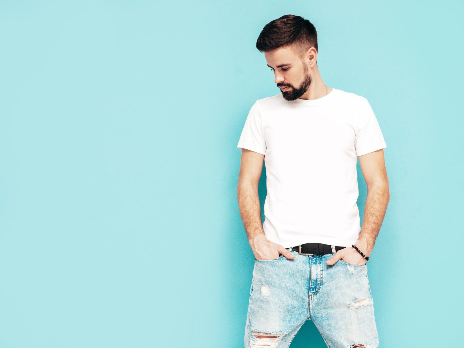 portrait-handsome-confident-stylish-hipster-lambersexual-modelman-dressed-white-tshirt-jeans-fashion-male-isolated-blue-wall-studio_158538-24547
